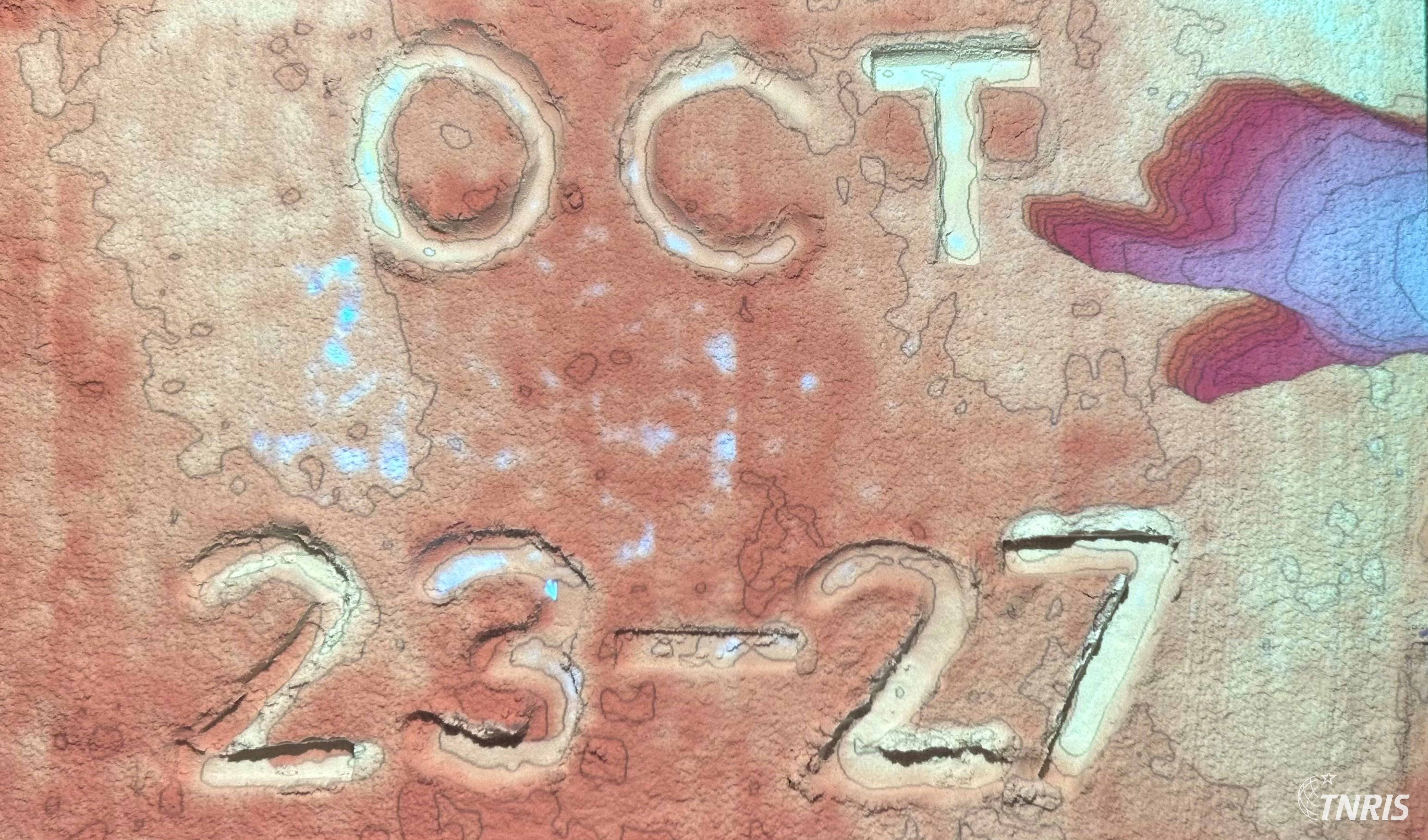 Oct 23-27 written in LiDAR sand with pointing hand